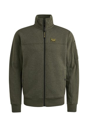 Veste zippée vert olive avec un panneau supérieur texturé, une section inférieure lisse et un patch de logo sur la poitrine. Dispose d'un col montant et de poches latérales.