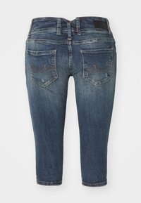 Denim jeans in dark blue, featuring a straight cut, mid-rise waist, subtle fading, and two back pockets with stitch detailing.
