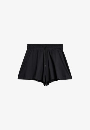 Zwarte sportshorts met een trekkoord in de taille, gemaakt van zacht materiaal. Beschikt over een losse pasvorm en een voering van handige mesh voor flexibiliteit.