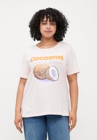 Light pink t-shirt with short sleeves, featuring an illustrated coconut graphic and orange text reading "Coconut." Soft cotton material.