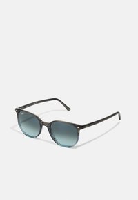 Ochelari de soare cu gradient negru, cu ramele rotunde, realizate dintr-un material plastic neted. Lentilele sunt de culoare smarald închis, cu un accent metalic cu logo pe templu.