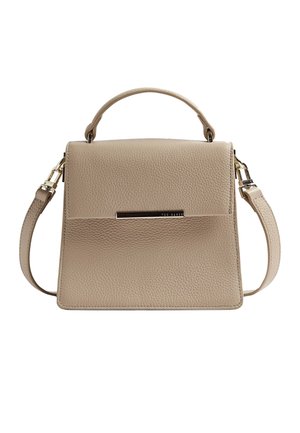 Beige textured leather handbag with top handle, detachable shoulder strap, and metal brand name plate on front flap.