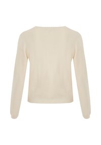 Krämmfärgad långärmad stickad tröja med ribbad fåll och enkel rund halsringning, visad bakifrån mot en vit bakgrund.