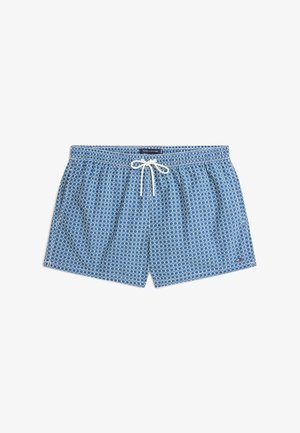 Blå badetrusser med hvidt geometrisk mønster, elastisk taljebånd og hvid snor bundet i en sløjfe foran i midten.