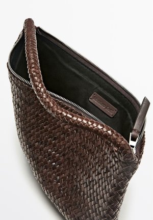 Woven brown leather bag with a zippered closure, featuring a textured exterior and a smooth black interior lining.