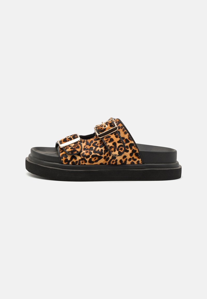 Leopard-print slide sandals with dual straps, gold hardware, and a black rubber sole. Soft textile upper and flat design.