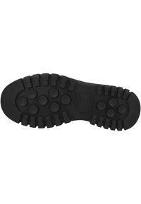 Black rubber shoe sole with circular and rectangular tread patterns for enhanced grip and durability, size marked as 42.