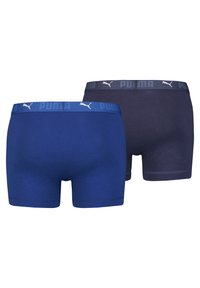 Dos pares de bóxer en navy y azul real. Ambos cuentan con una suave cinturilla con el logo de Puma. El tejido parece liso y elástico.