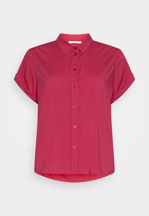 Short-sleeve button-up shirt in vibrant pink. Features a classic collar, smooth texture, and curved hem. Simple design with no patterns.