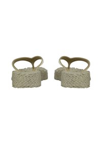 Beige platform sandals with woven texture, wide straps, and heart-shaped cutouts. Material appears rubbery with a smooth finish.