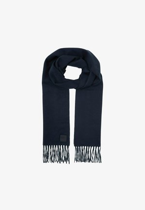 Écharpe bleu marine en tissu doux, avec des détails en franges aux extrémités et une petite étiquette de marque rectangulaire. Forme rectangulaire avec une texture lisse.