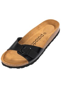 Sandale à glissière en cuir noir avec boucle ajustable, semelle en liège et semelle extérieure en caoutchouc texturé. La semelle intérieure présente une finition en daim naturel.