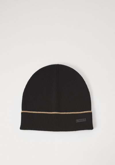 Bonnet en tricot noir avec une bande d'accent dorée autour du revers. Comprend une petite étiquette logo en textile sur le poignet. Texture lisse.