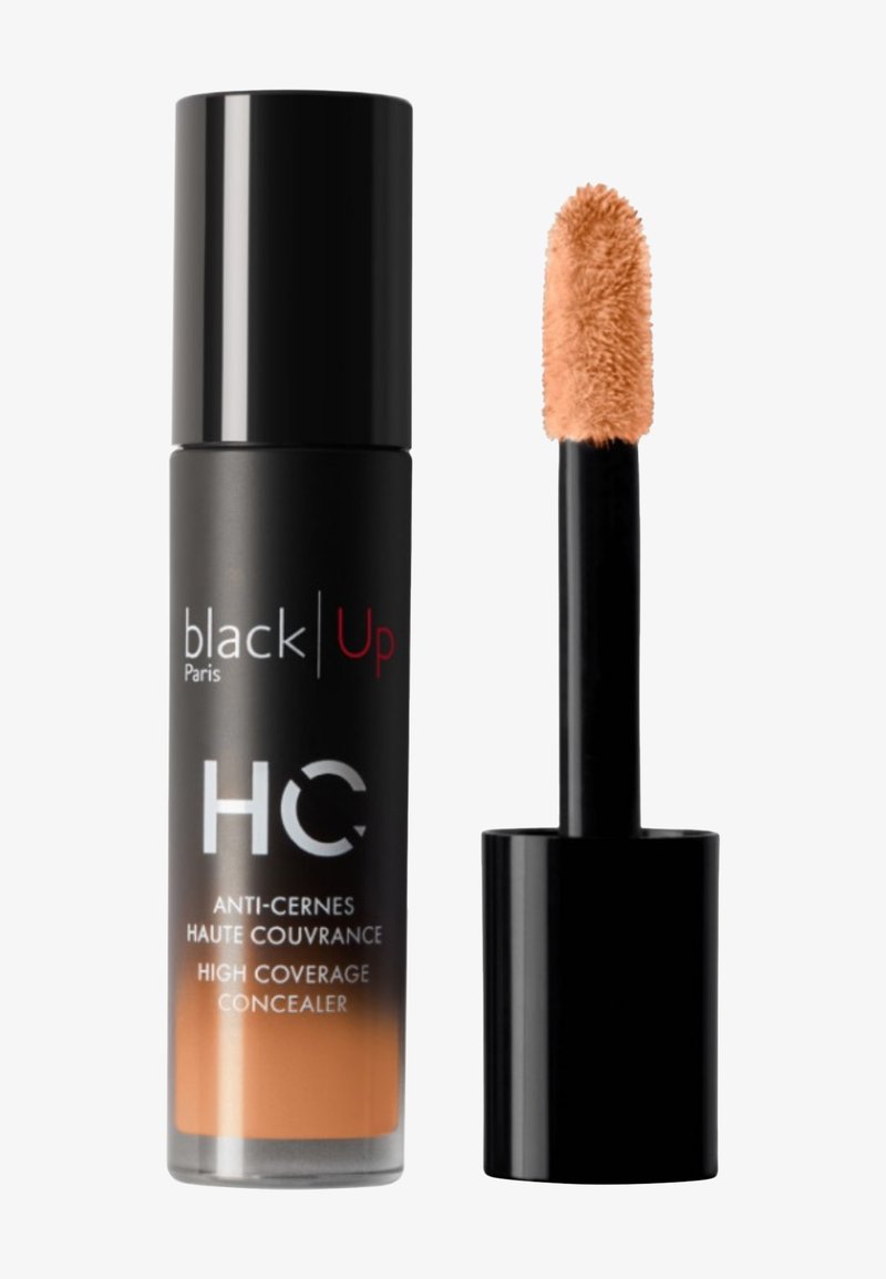 Flacon de correcteur haute couvrance Black Up Paris avec applicateur montrant un correcteur liquide beige.