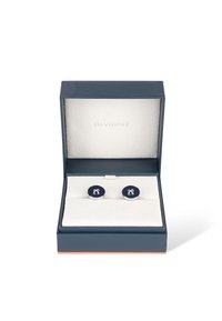 Silberne Manschettenknöpfe mit einem dunkelblauen, kreisförmigen Design, das ein strukturiertes Muster aufweist. Präsentiert in einer blauen Box mit weißem Innenraum und Davidoff-Branding.