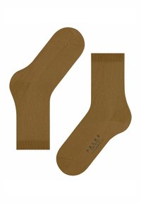 Un paio di calzini marroni fino alla caviglia con orli a coste, uno dei quali mostra un testo di marca sulla suola che recita "FALKE COSY WOOL."
