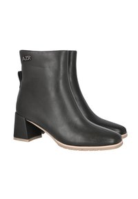 Botines de cuero negro con punta afilada y tacón bloque, con detalles de costuras y una pequeña pestaña para tirar en la parte trasera.