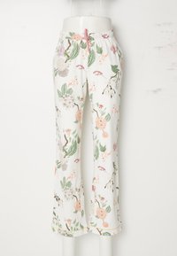 Floral print pajama pants, white background, elastic waist with a pink drawstring, light-weight fabric, features flowers and leaves pattern.