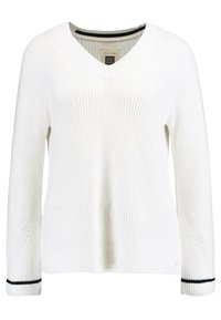 Pull blanc en tricot avec col en V et manches longues. Tissu texturé avec des accents noirs aux poignets. Étiquette de la marque visible à l'intérieur.