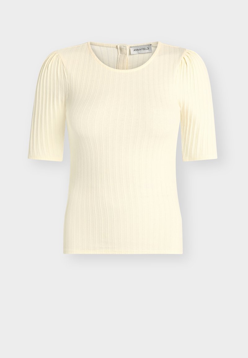 Μπλούζα σε κρεμ απόχρωση με ριπ ύφανση και κοντά μανίκια με ελαφρώς φουσκωτούς ώμους και στρογγυλή λαιμόκοψη, κλείσιμο με φερμουάρ στο πίσω μέρος, με ετικέτα Anna Field εμφανή.