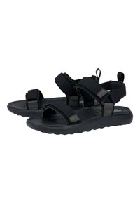 Sandales noires avec des sangles en tissu réglables, une semelle intermédiaire rembourrée, un coussin de pied texturé et une semelle externe flexible avec des contours en forme de vagues.