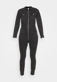 Combinaison en jean noire à manches longues, fermeture éclair à l'avant, deux poches poitrine et jambes fuselées. Elle possède un col et un tissu texturé.