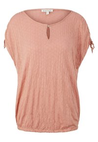 Blouse courte texturée rose clair avec manches courtes, fermeture par bouton à l'encolure clé et petits liens sur les manches retroussées, ourlet élastiqué.