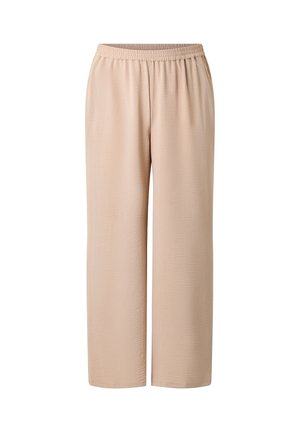 Beige vidde bukser med elastisk talje, glat stof og uden synlige lommer eller mønstre, vist på en hvid baggrund.