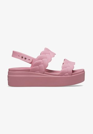 Różowe sandały na platformie z plecionym paskiem, wykonane z elastycznego materiału. Posiadają regulowany pasek na piętę oraz teksturowaną wkładkę.