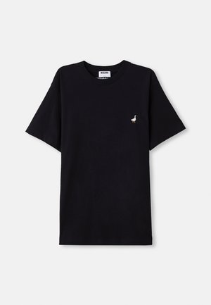 T-shirt noir en coton à manches courtes, avec un petit accent brodé de cane sur la poitrine et un col ras du cou.