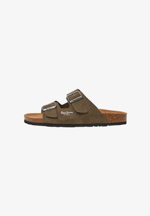 Brown suede sandal with two adjustable metal buckle straps, cork footbed, and black rubber outsole. Features logo on the upper side.