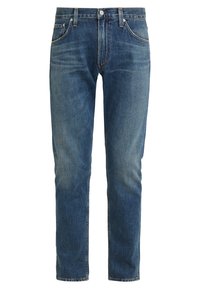 Blå denim jeans med rak benklipp, med utvättade områden, fem fickor och metalldragkedja. Klassisk sömnad och varumärkesspecifika detaljer.