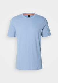 T-shirt en coton bleu clair à manches courtes, col rond et petit logo embossé sur la poitrine.