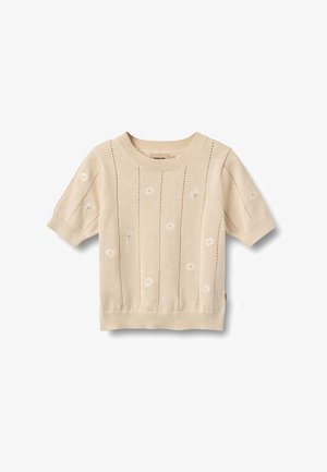 Beige korte mouw gebreide trui met kleine witte madeliefjesborduur en verticale opengebreide strepen.