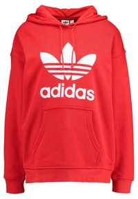 Röd Adidas hoodie med vit trefoil-logotyp, framficka i känguru-stil, dragsko i huvan, samt ribbade muddar och nederkant.