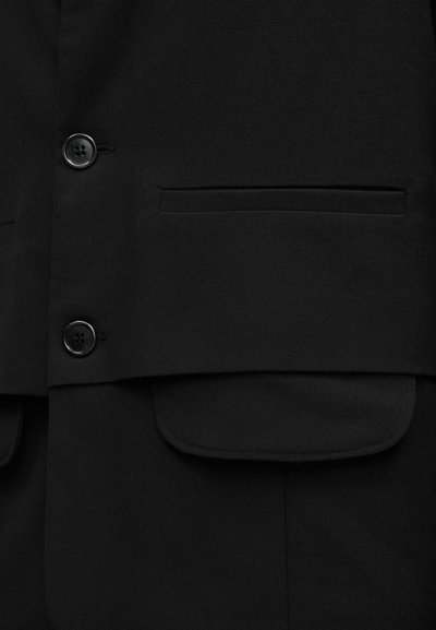 Μαύρο σακάκι με λεία υφή, δύο κουμπιά στο μπροστινό μέρος και μία τσέπη με καπάκι. Απλός και κομψός σχεδιασμός.