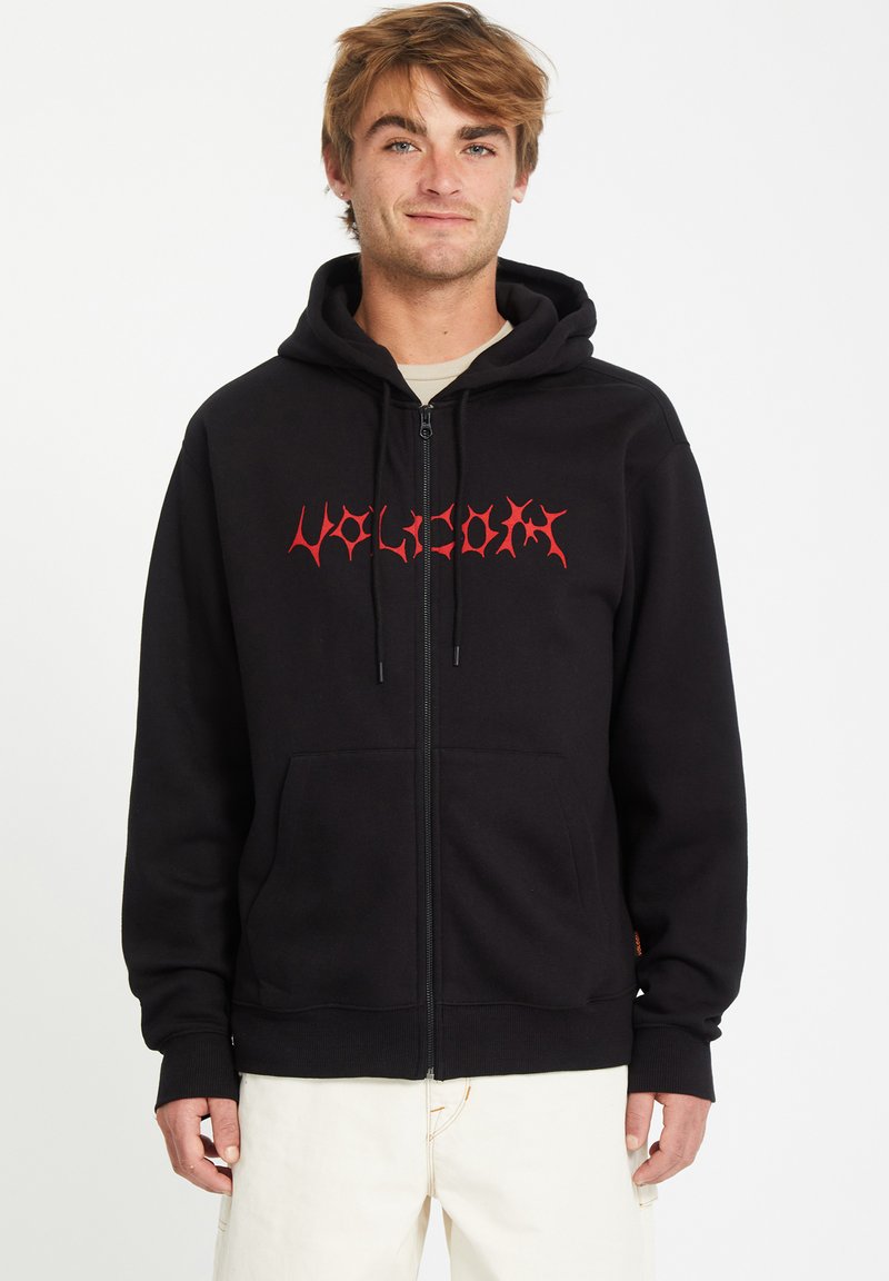 Zwarte zip-up hoodie met een gestileerd rood "Volcom"-logo. Beschikt over een frontzak, trekkoordcapuchon en ribgebreide manchetten en onderzijde.