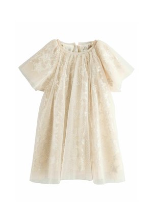 Robe enfant crème à manches courtes, forme évasée, en tissu transparent avec un subtil motif d’étoiles scintillantes.