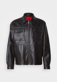 Black leather jacket with a front zipper, two chest pockets, and a red interior lining. Features a classic collar and relaxed fit.
