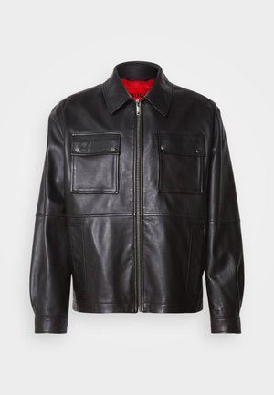Black leather jacket with a front zipper, two chest pockets, and a red interior lining. Features a classic collar and relaxed fit.