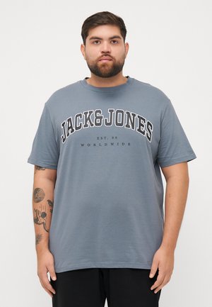 Gray short-sleeve T-shirt with “JACK & JONES” in bold black letters. Features a round neckline and relaxed fit, with smooth cotton texture.