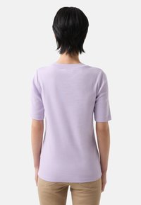 Light purple short-sleeve t-shirt with a round neckline, smooth texture, and a fitted design. Seamless back with no visible patterns or accents.