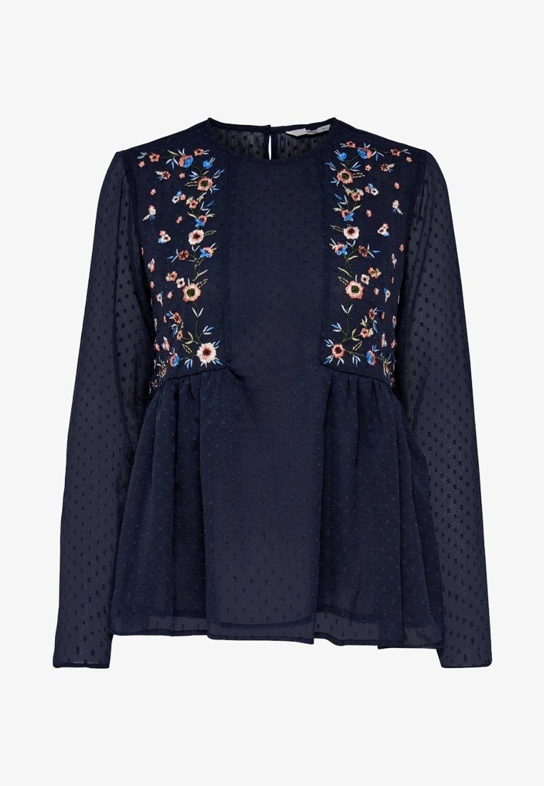 Blouse bleu marine à manches longues en tissu transparent, avec des points texturés et une broderie florale sur les panneaux avant et les épaules.