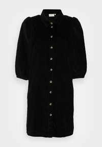 Abito in corduroy nero con scollo a colletto, maniche a sbuffo e chiusura frontale con bottoni, caratterizzato da bottoni circolari lungo la patta.
