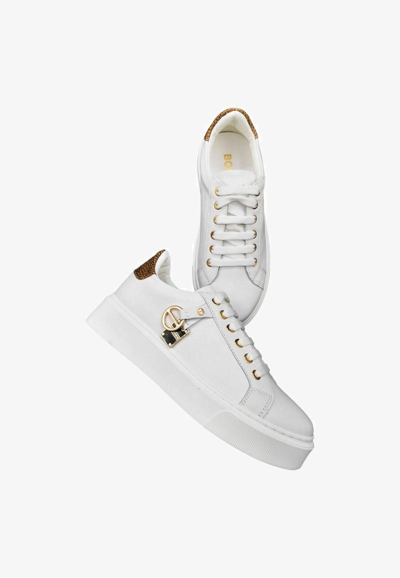 White sneakers made of smooth leather with a textured brown accent on the heel, gold hardware, and a flat rubber sole. Features a lace-up design.