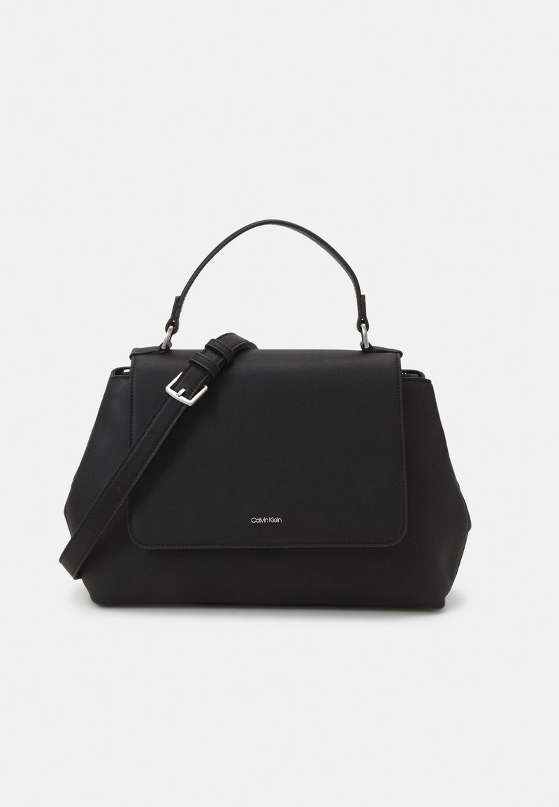 Black structured handbag with top handle and adjustable shoulder strap, featuring a front flap and small Calvin Klein logo.