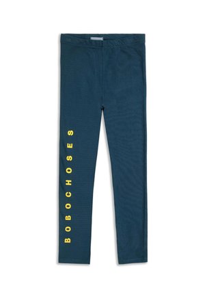Leggings de color verde oscuro hechos de un tejido suave, con texto vertical amarillo "BOBOCHOSES" en el lateral exterior de la pierna izquierda.