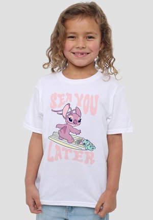 White cotton t-shirt featuring a colorful cartoon design of a character surfing with a smaller character below. Text says "SEA YOU LATER."