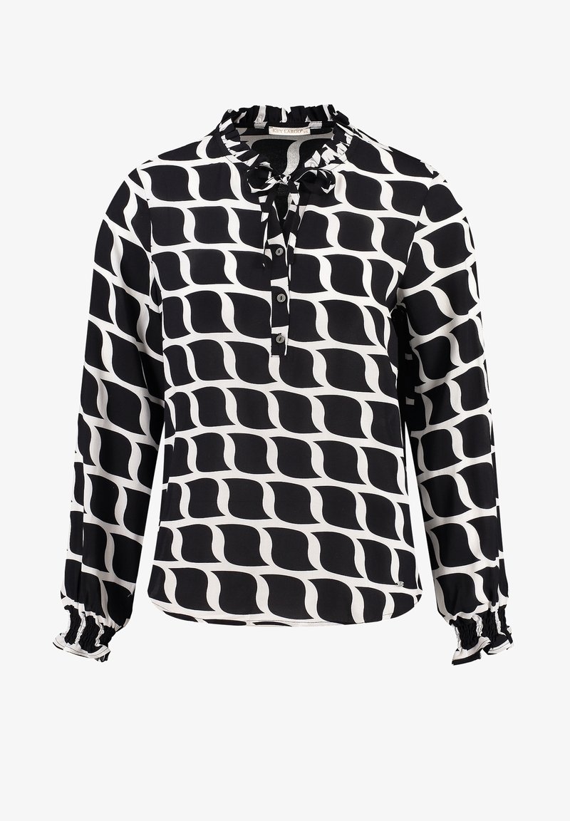 Blouse à manches longues noire et blanche à motifs, avec col à volants, patte de boutonnage sur le devant et poignets élastiques.
