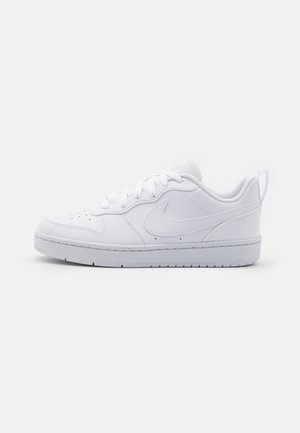 White leather sneakers with a low-cut design, textured tongue, perforated toe box, and a rubber sole. Features a tonal logo on the side.